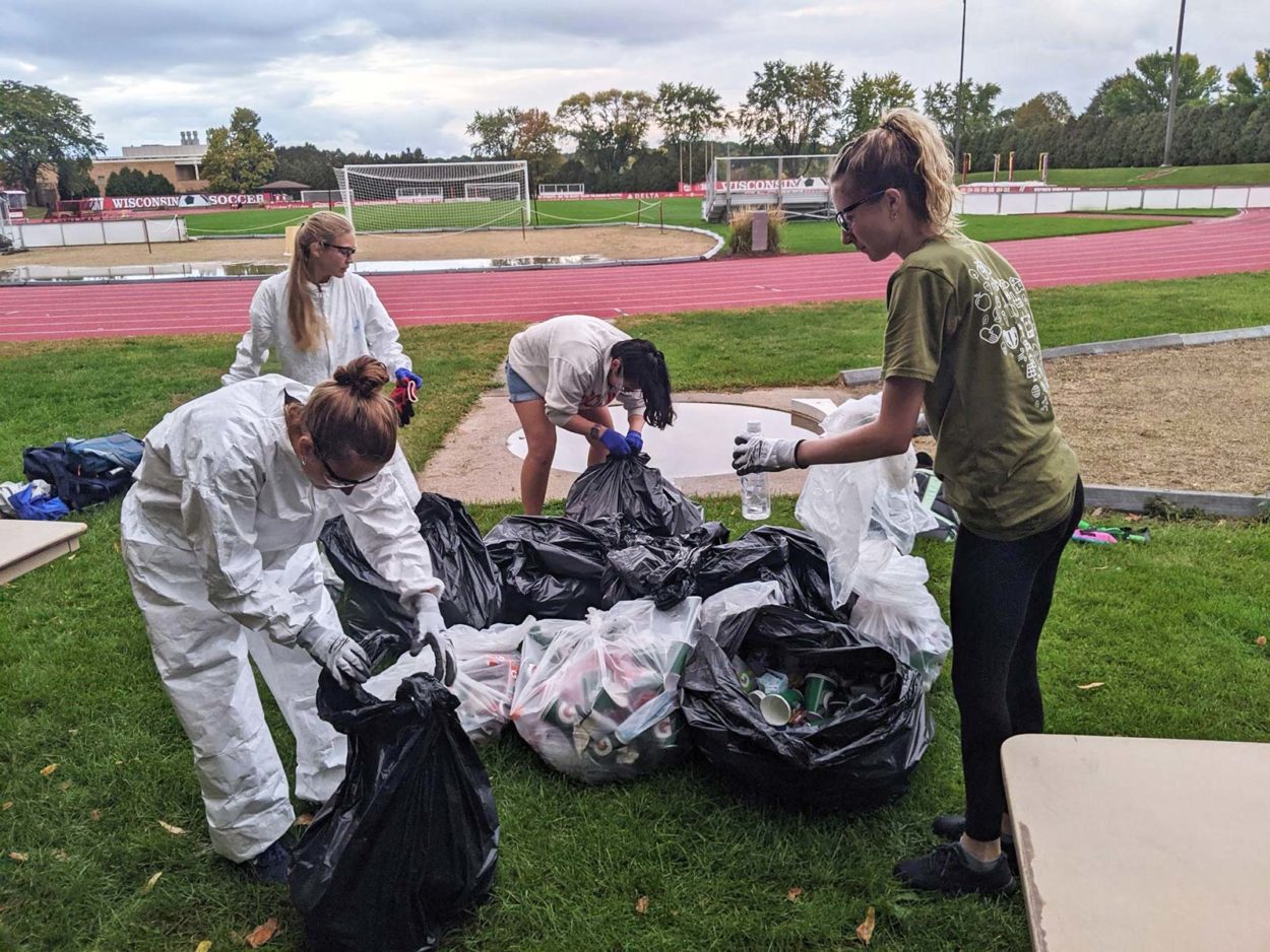 Students clean up sports field on the campus of University of Wisconsin-Madison, as part of Campus Race to Zero Waste.