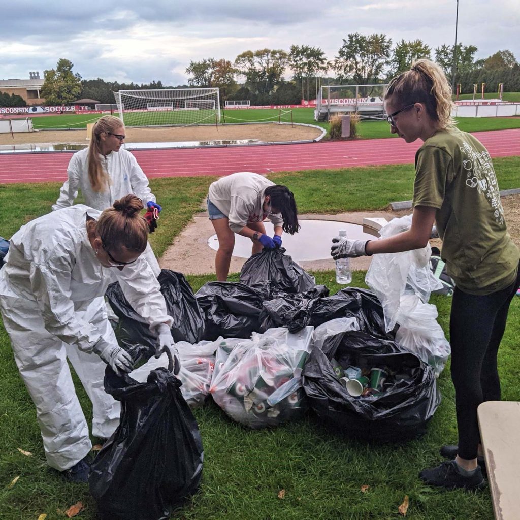 Students clean up sports field on the campus of University of Wisconsin-Madison, as part of Campus Race to Zero Waste.