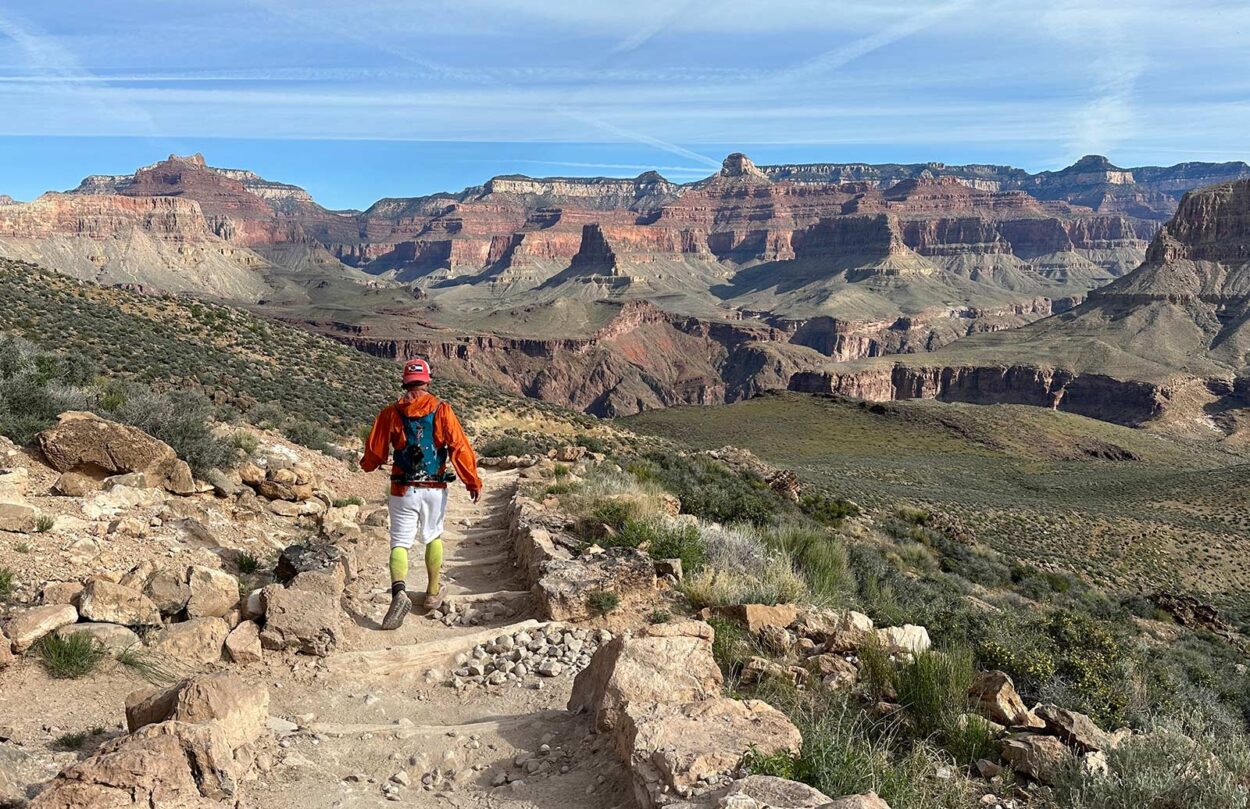 Hiker walks down a path in the Grand Canyon