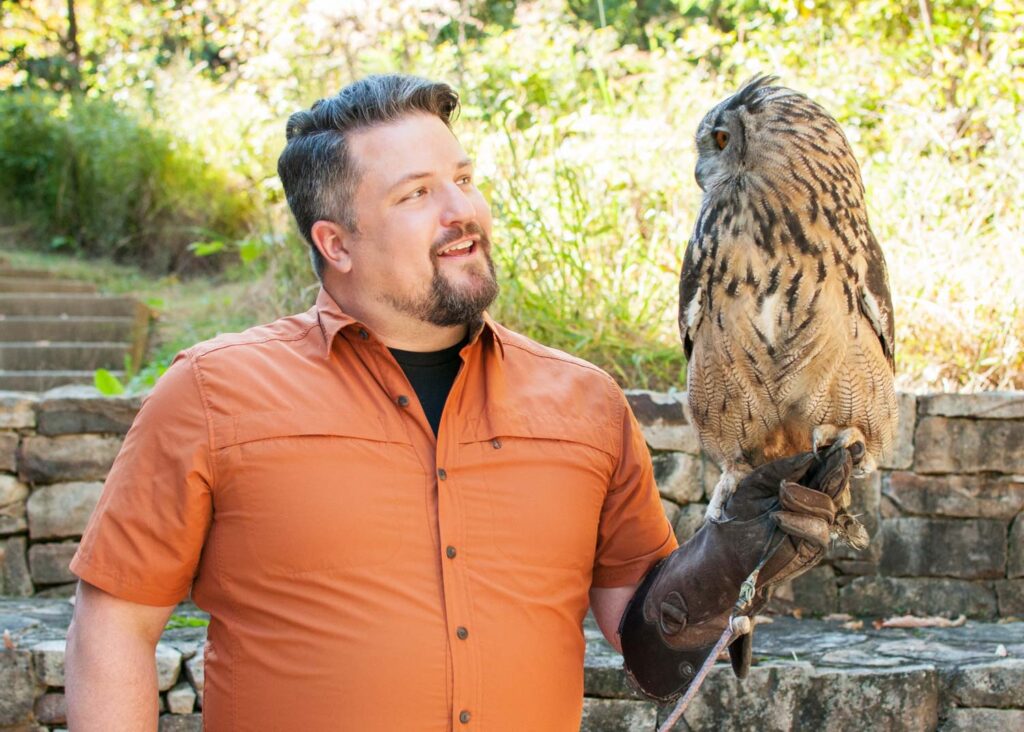 Dave Mizejewski holds an Eagle Owl.
