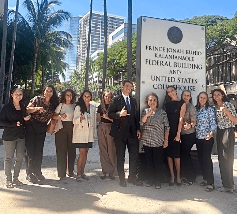 A group of people standing in front of the Prince Jonah Kuhio Kalanianaole Federal Building